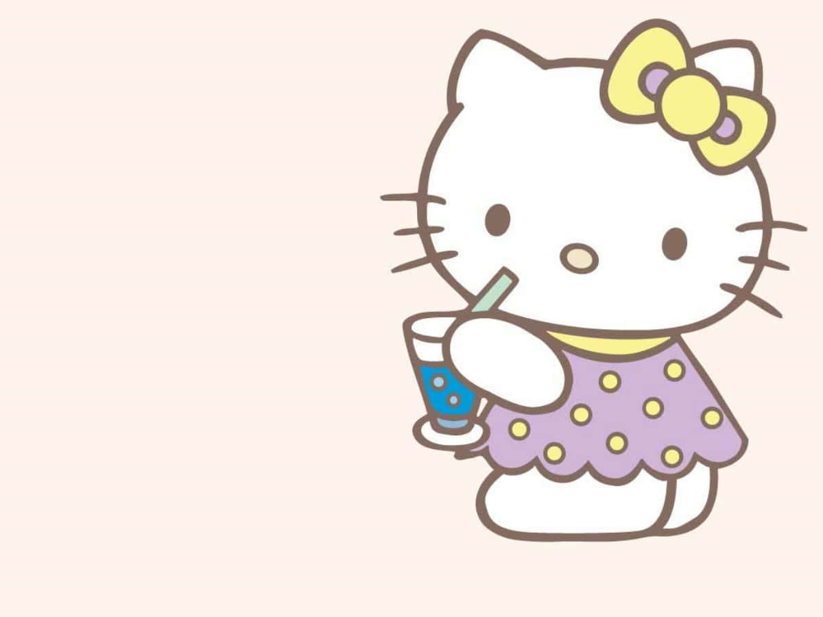 Hello Kitty п'є напій за ноутбуком Шпалери