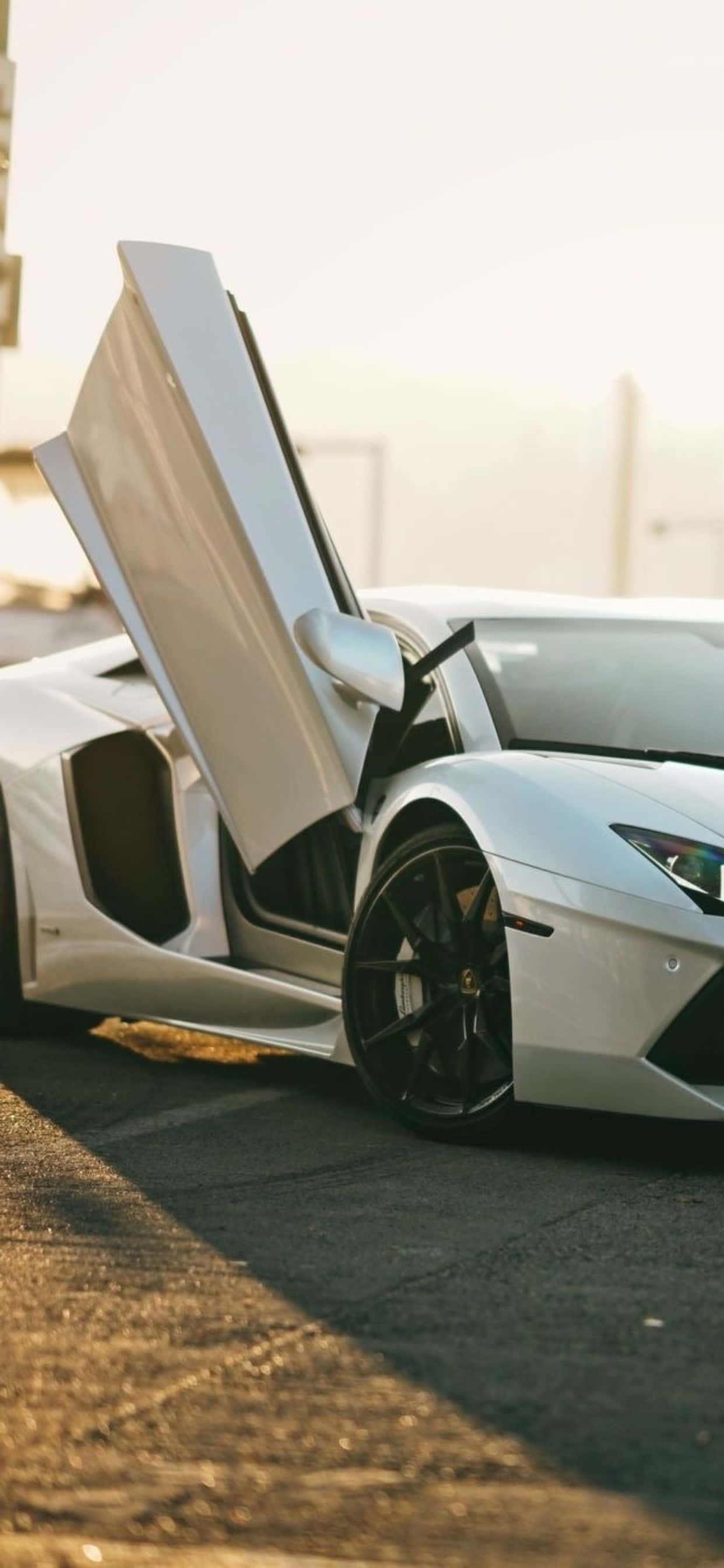 iPhone XS Max на фоне Lamborghini Aventador Roadster Шпалери