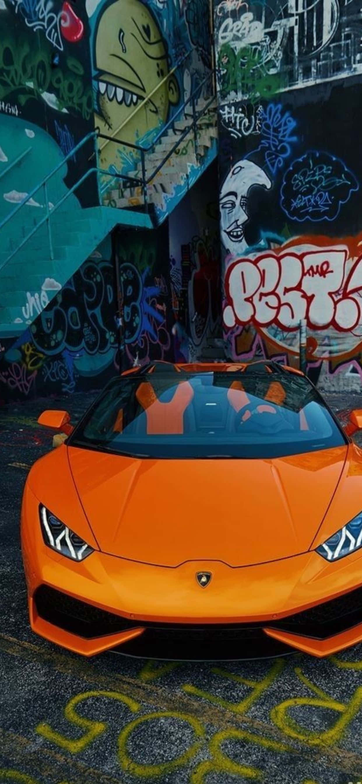 iPhone XS Max на фоне Lamborghini Huracan оранжевого кольору Шпалери