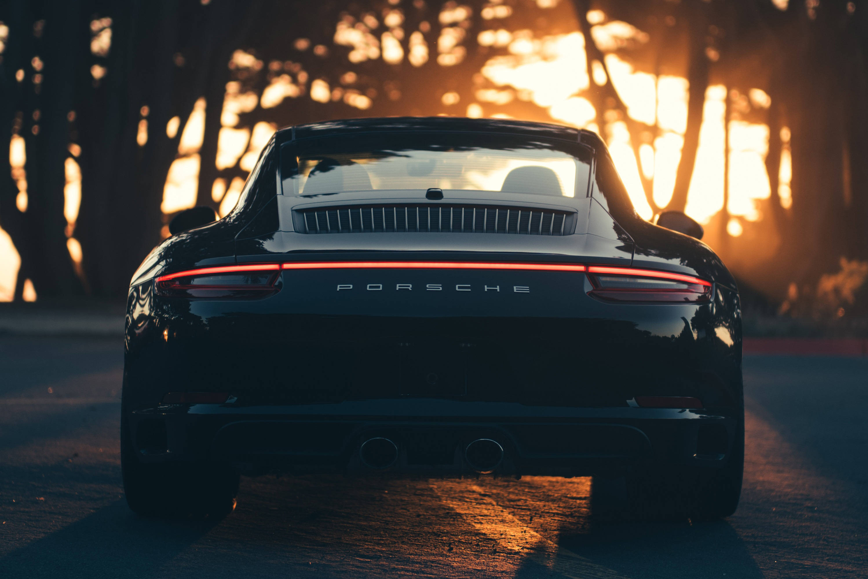 Чорний Porsche 911 спостерігає за заходом сонця Шпалери