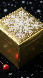 Блистающий золотой подарок со снежинками на черной поверхности с ягодой. — iPhone 7 Шпалери